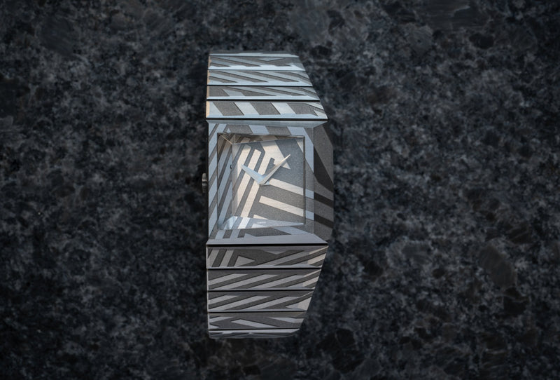 The B/1 Dazzle carries its geometric titanium pattern across dial, case and bracelet.